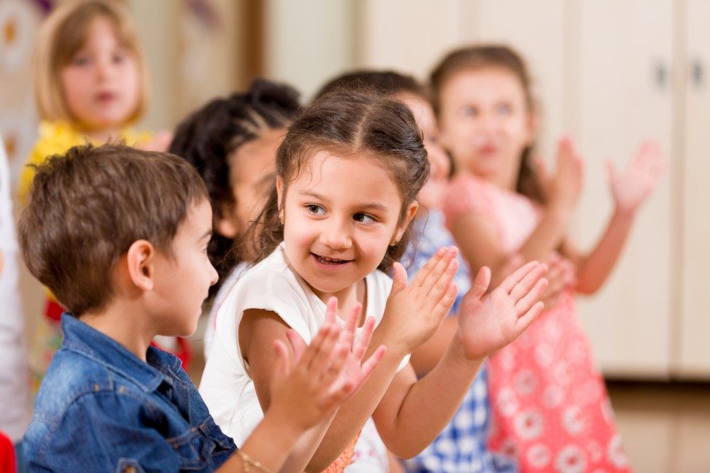 Children clapping together